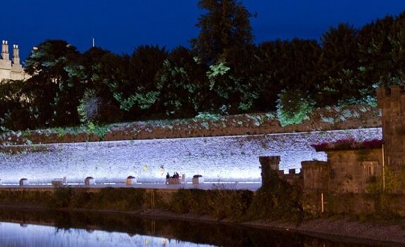 Kilkenny Castly at night, lit up with purple lights