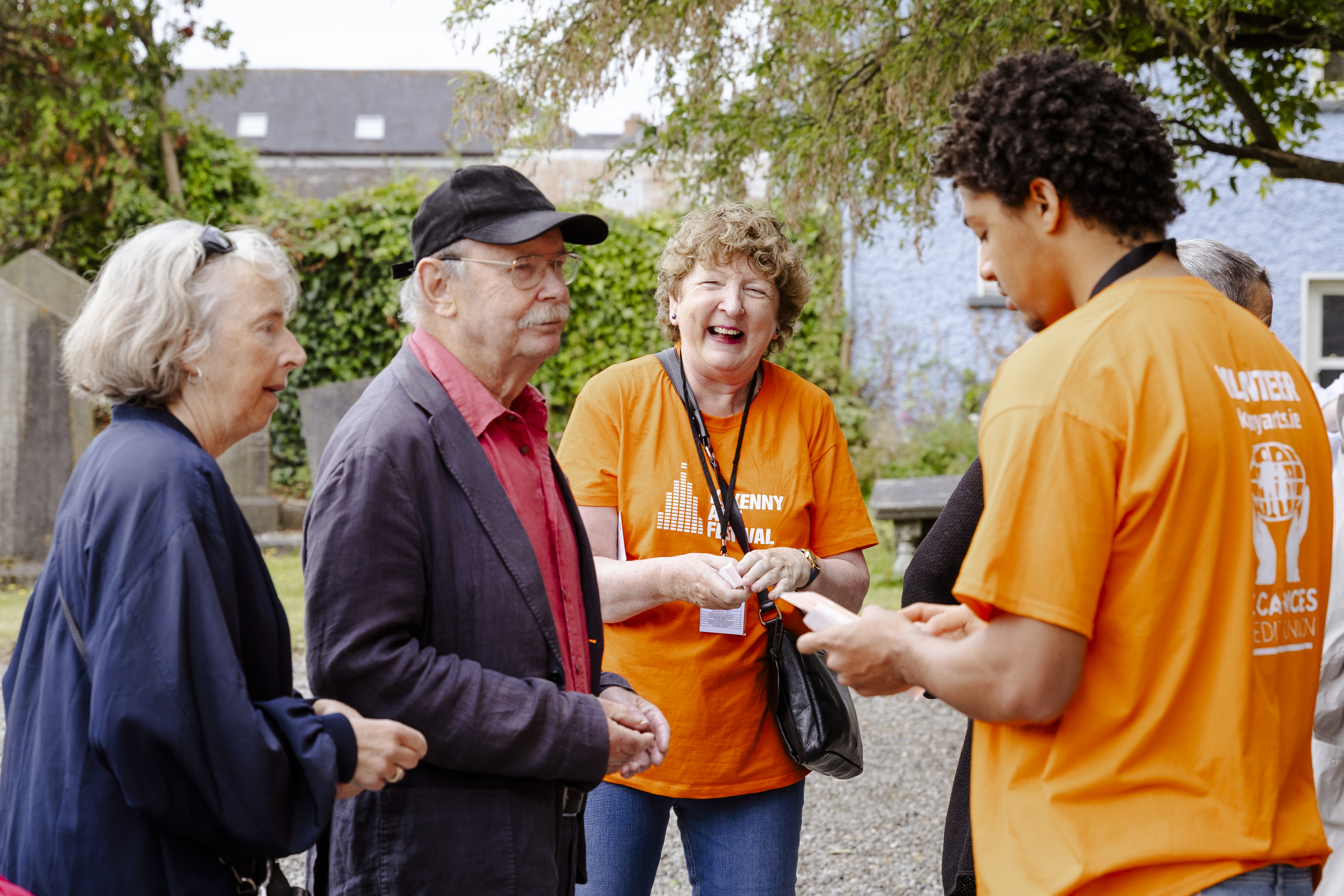 Festival volunteers talking and laughing with festival goers