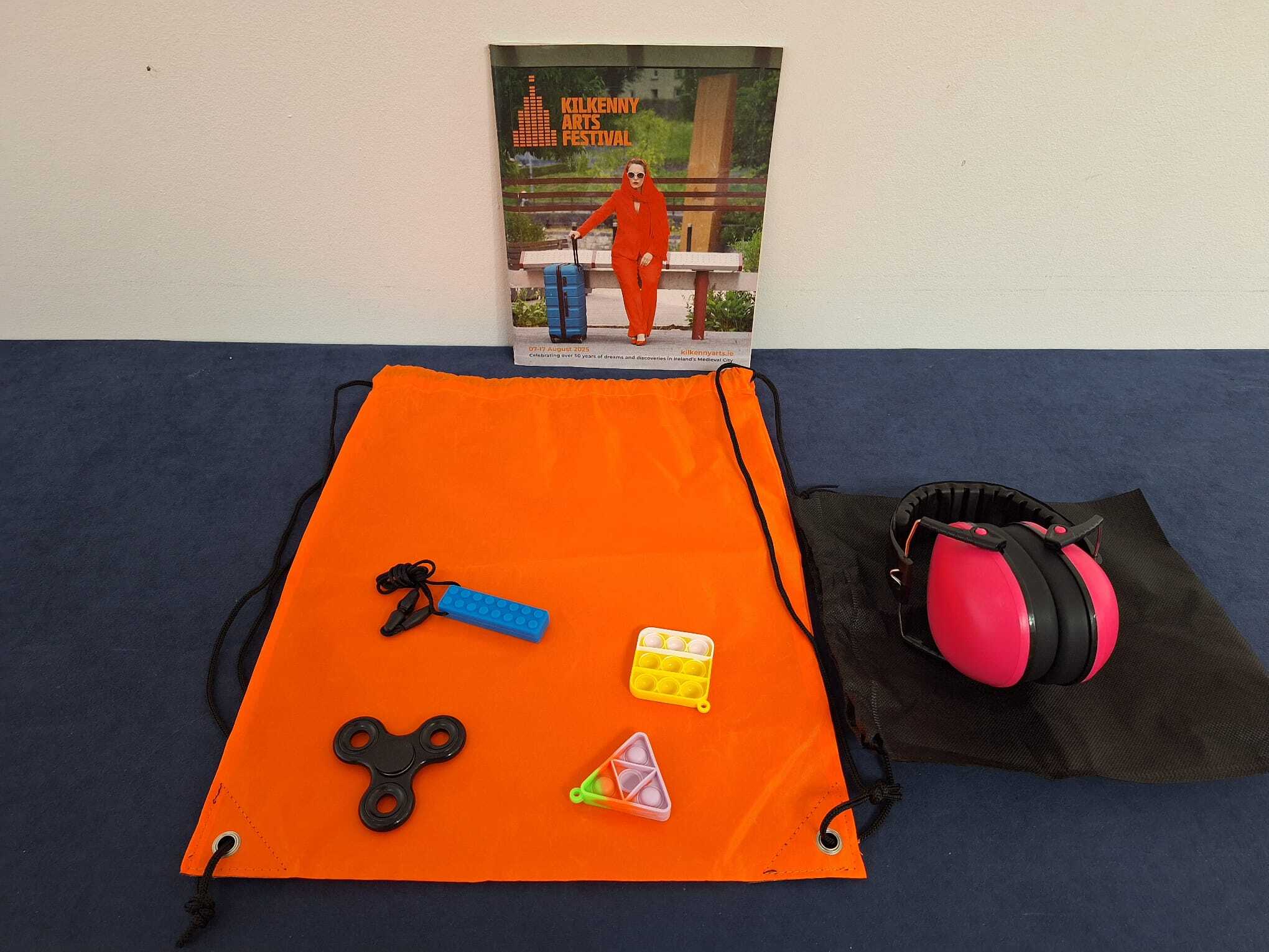 Contents of KAF Sensory Packs including ear defenders, fidget toys and a programme.