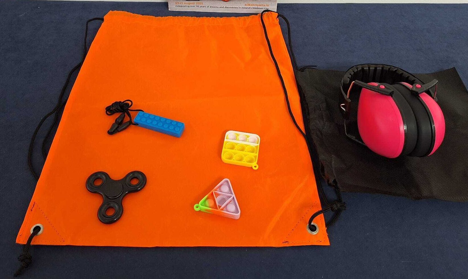 Contents of KAF Sensory Packs including ear defenders, fidget toys and a programme.